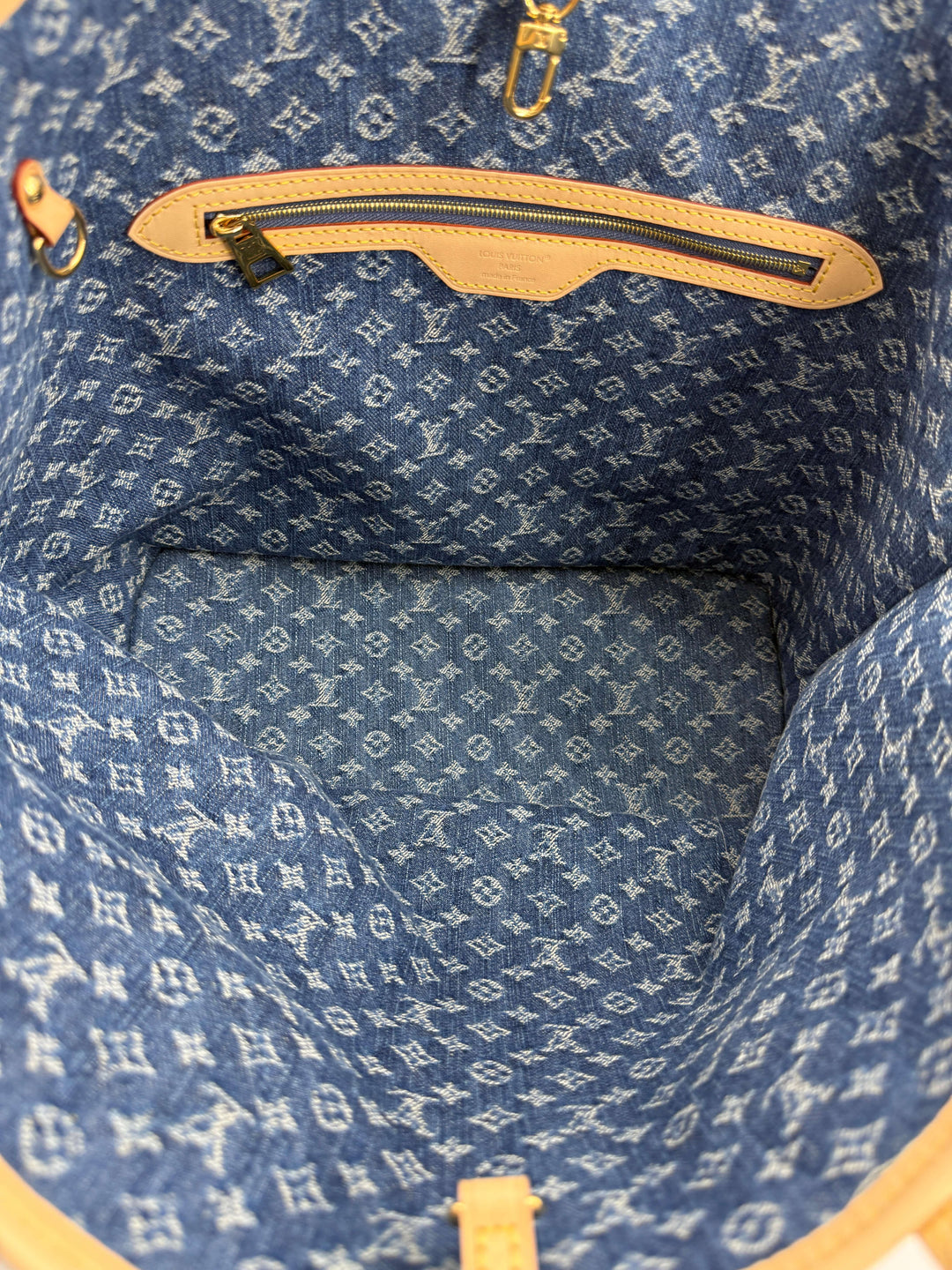 Interior view of the Louis Vuitton Neverfull MM Monogram Denim | LuxLoveLouis, showcasing its signature denim pattern and spacious design.