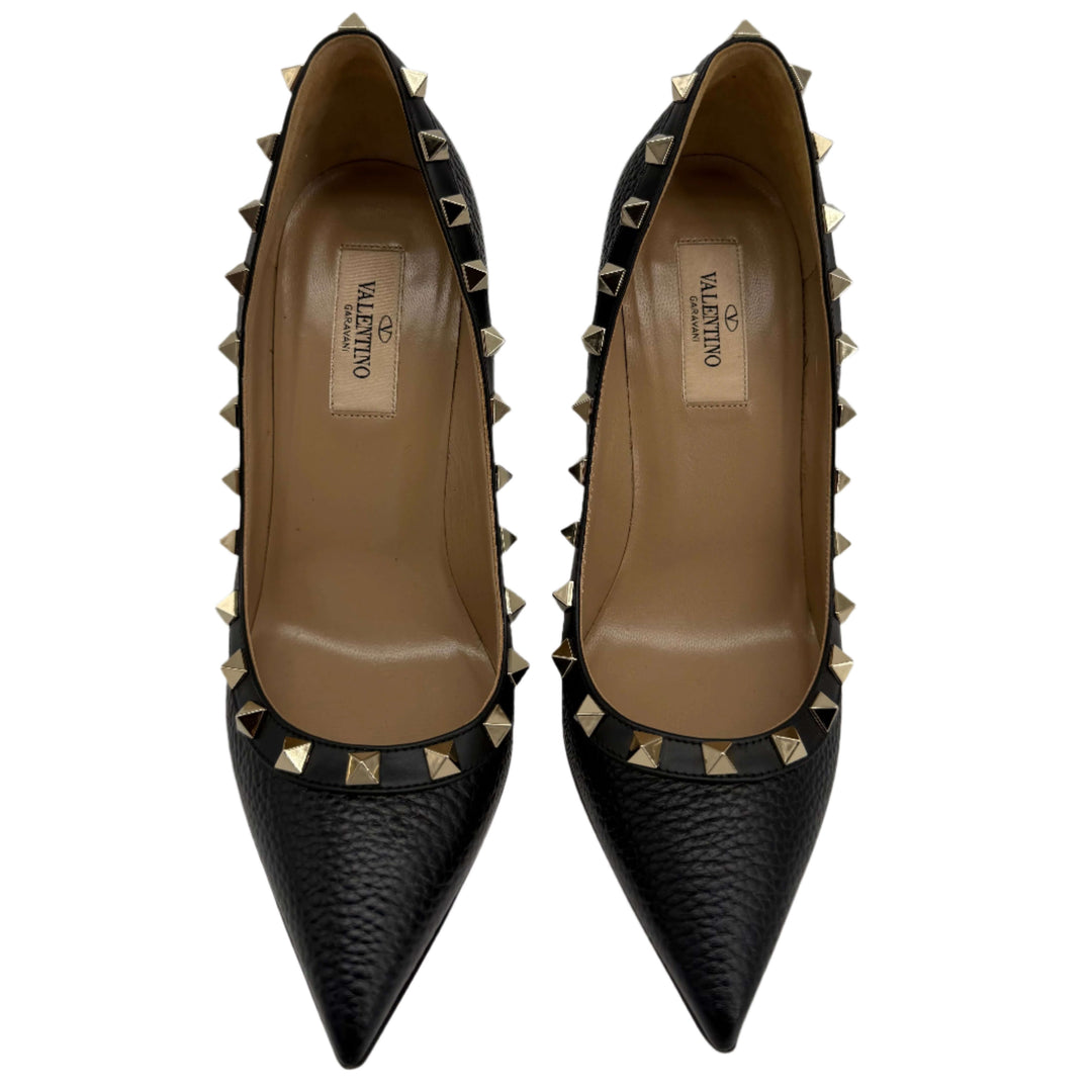 Valentino Garavani Rockstud Pumps with gold-tone studs and pebbled leather, black color, stylish pointed toe design.