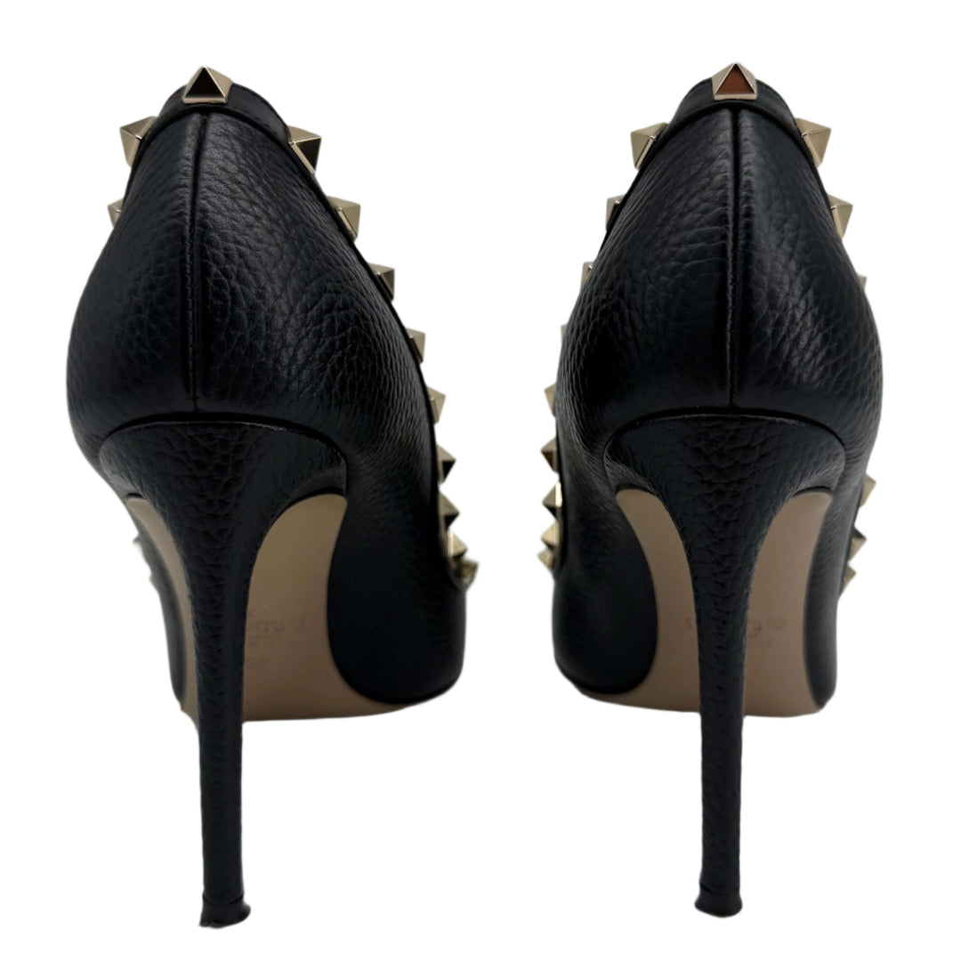 Valentino Garavani black pebbled leather Rockstud pumps with gold-tone studs on the heel.