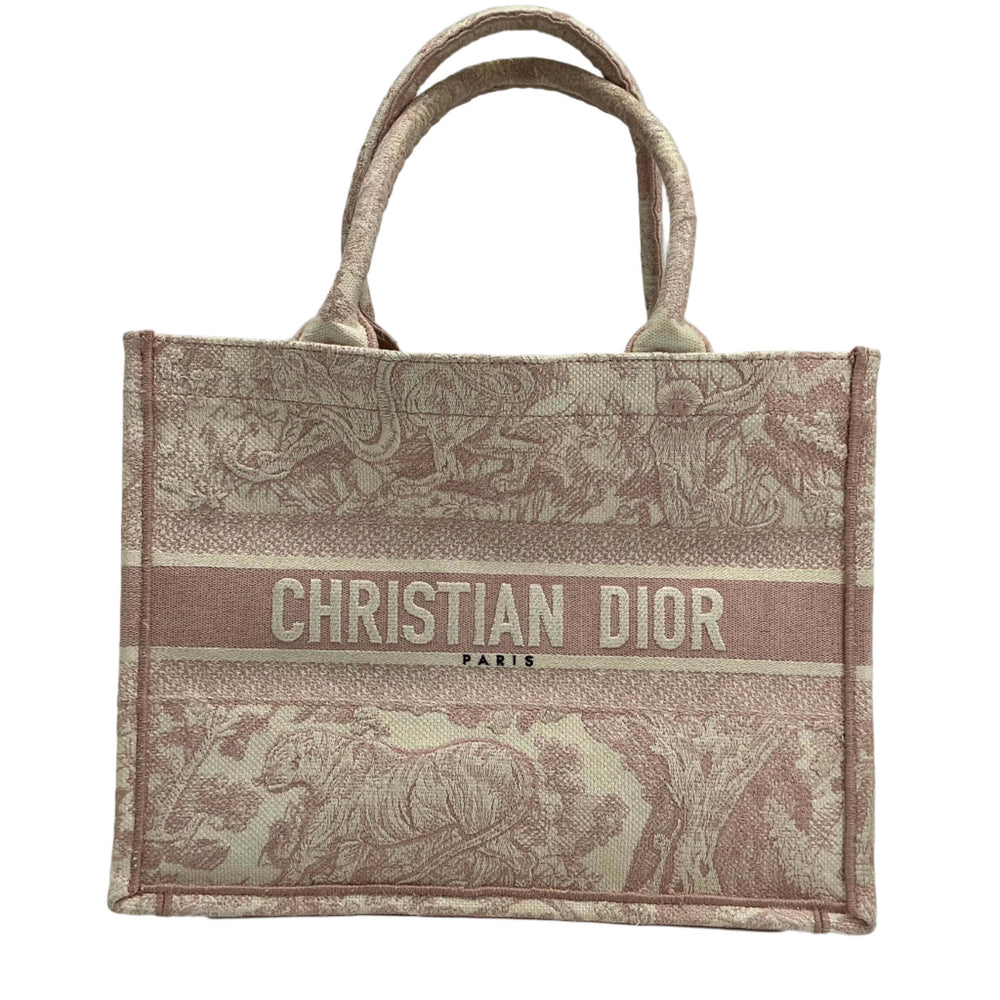 Christian Dior Medium Dioriviera Book Tote in rose Toile De Jouy canvas with embroidered motifs and logo detail.