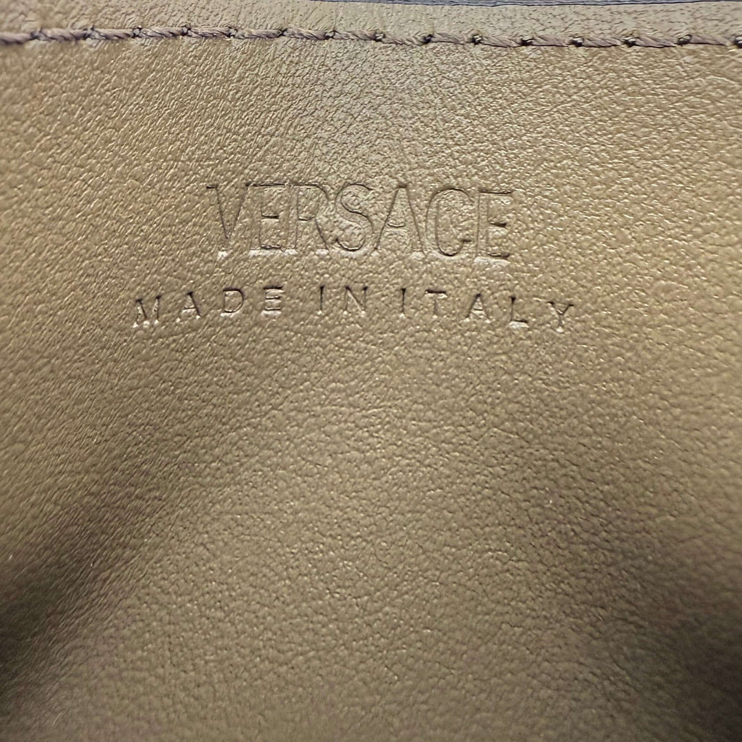 Versace leather interior with embossed logo, showcasing premium craftsmanship and luxury branding.
