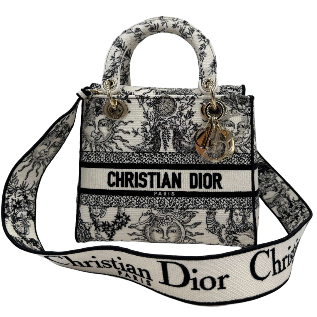 Christian Dior medium handbag in embroidered canvas with intricate design and logo, featuring stylish handles and adjustable strap.