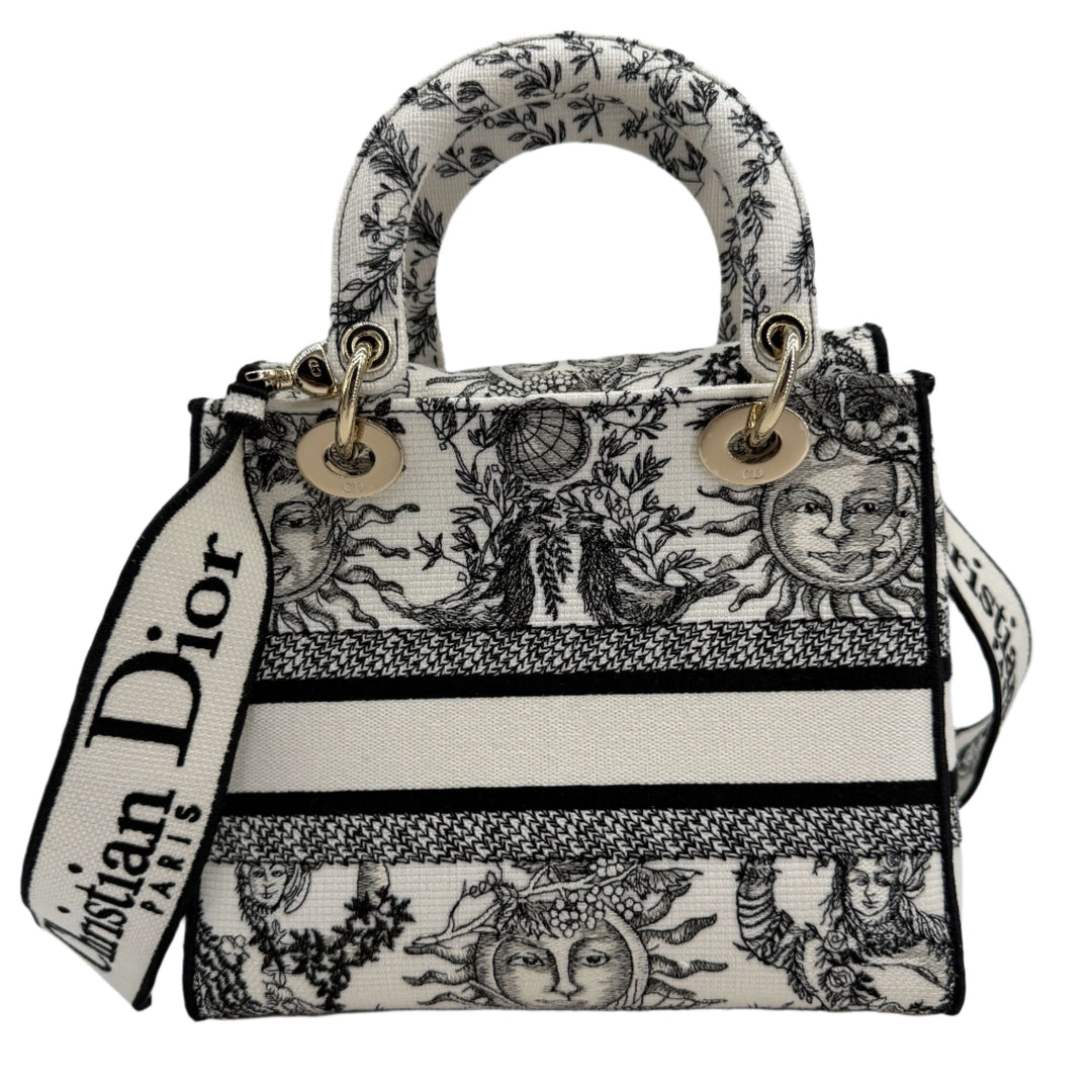 Christian Dior Lady D-Lite Medium Bag in embroidered black and white canvas with gold hardware, showcasing chic structure and modern design.