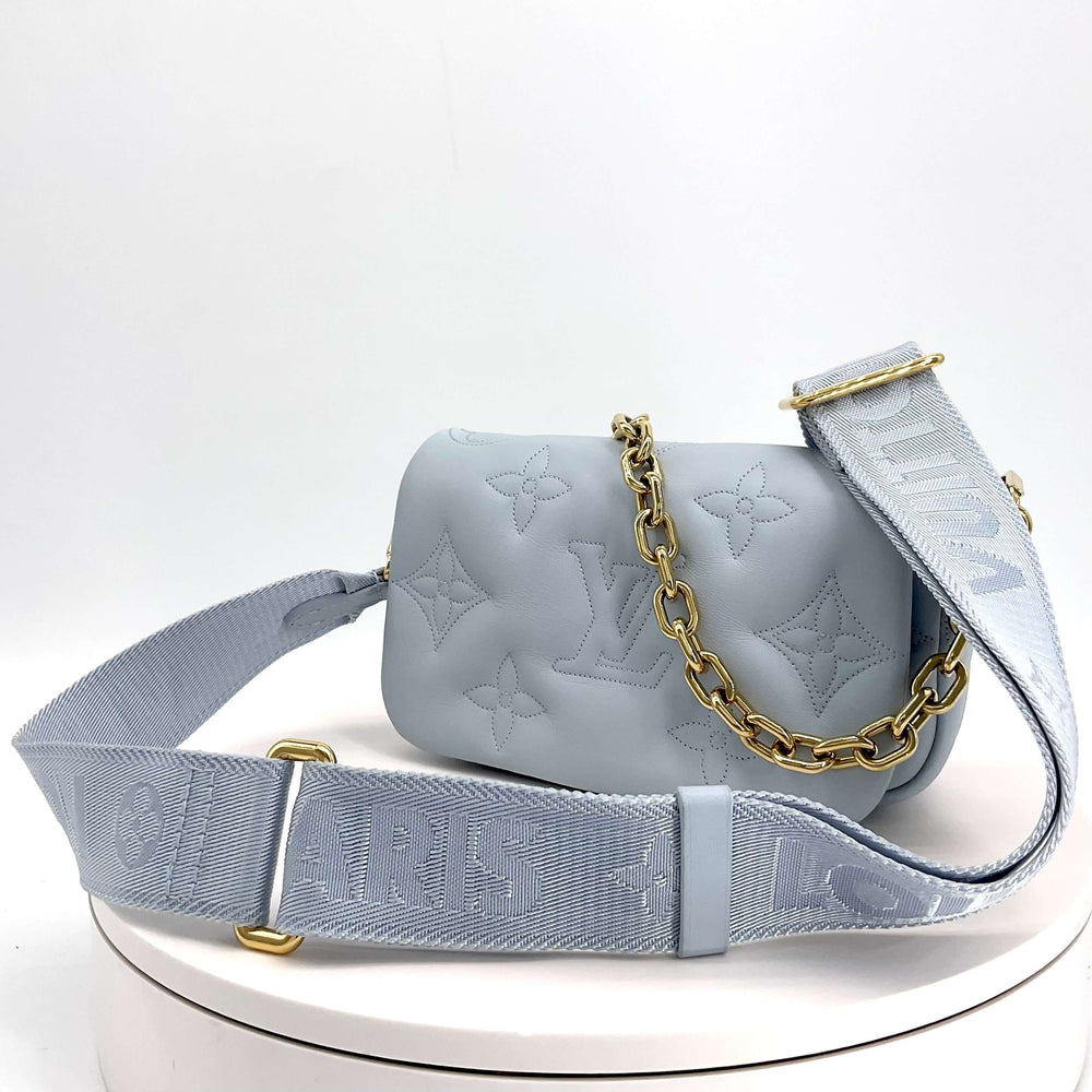 LOUIS VUITTON Calfskin Bubblegram Wallet On Strap in Ice Blue|LuxLoveLouis | Step into sophistication with the LOUIS VUITTON Calfskin Bubblegram Wallet On Strap in Ice Blue. Meticulously crafted from puffy calfskin and adorned with the iconic embossed LV