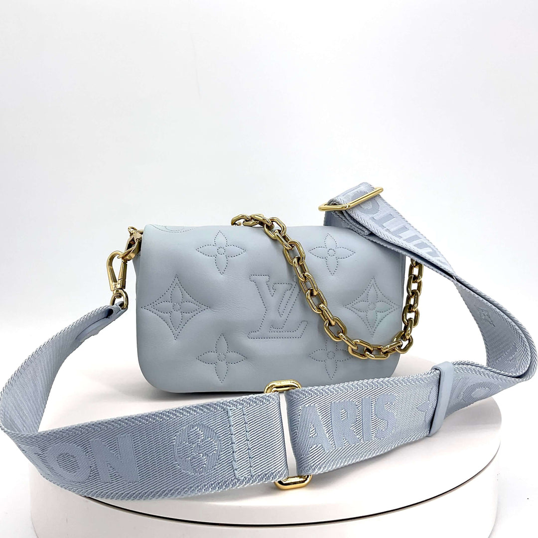 LOUIS VUITTON Calfskin Bubblegram Wallet On Strap in Ice Blue|LuxLoveLouis | Step into sophistication with the LOUIS VUITTON Calfskin Bubblegram Wallet On Strap in Ice Blue. Meticulously crafted from puffy calfskin and adorned with the iconic embossed LV