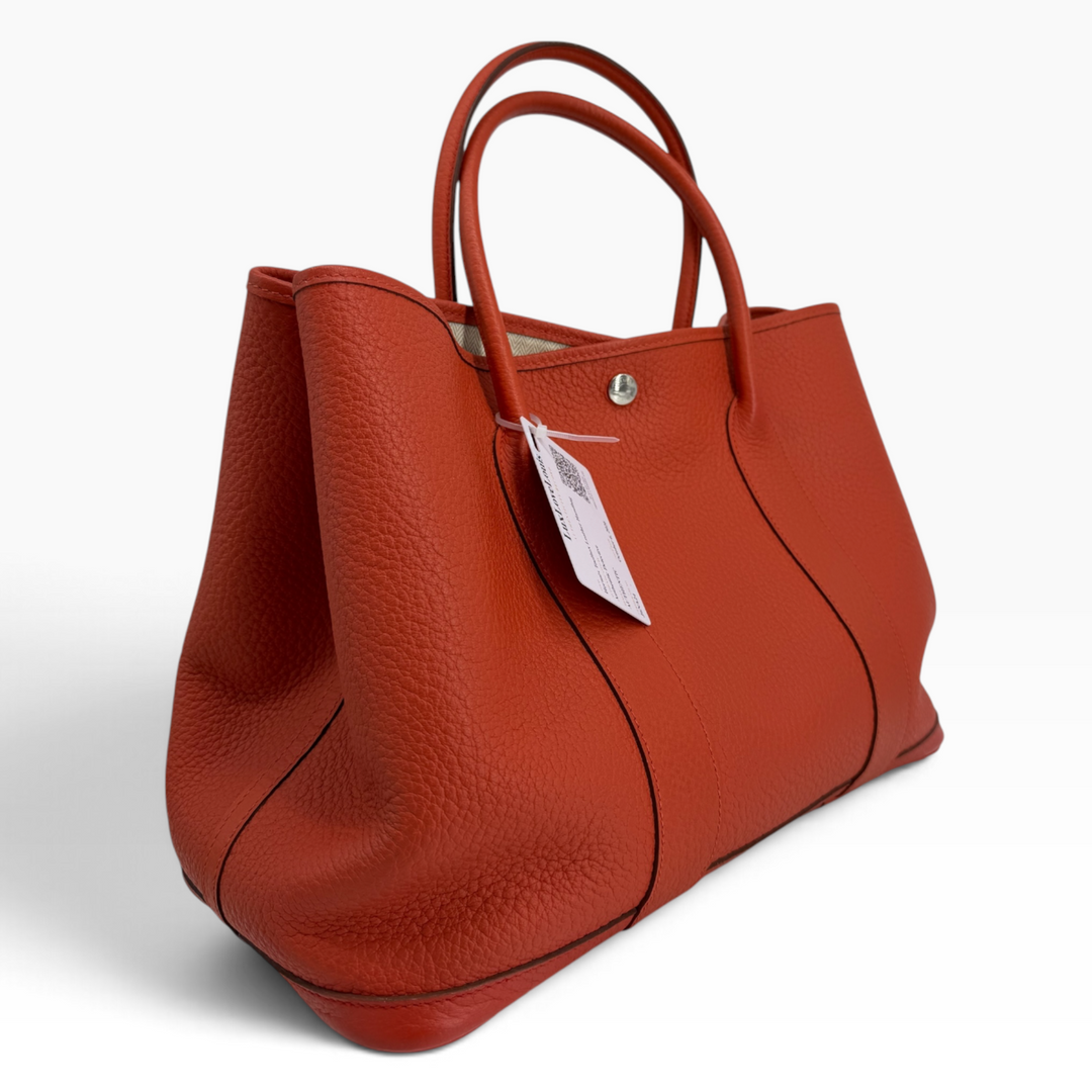Hermès Garden Party 30 Orange Poppy pebbled leather tote angled view showing side panel and handles