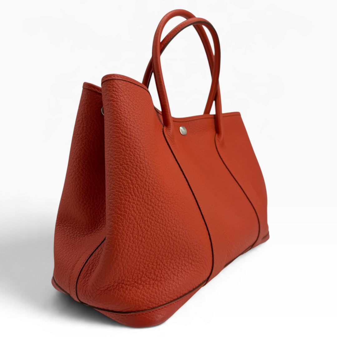 Hermès Garden Party 30 Orange Poppy pebbled leather tote angled view showing side panel and handles