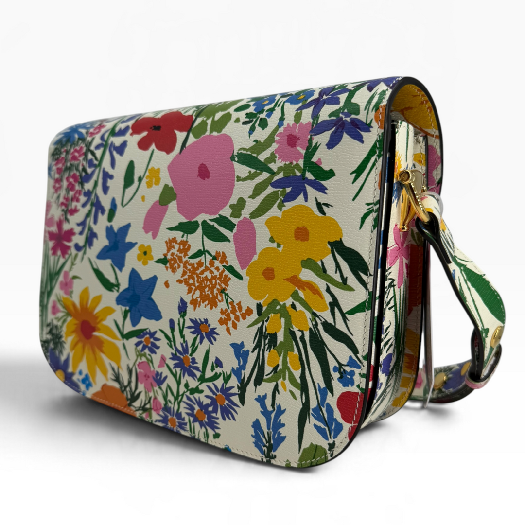 Rear view of Gucci x Ken Scott Horsebit 1955 Medium shoulder bag showing colorful floral print with pink blue yellow and orange flowers