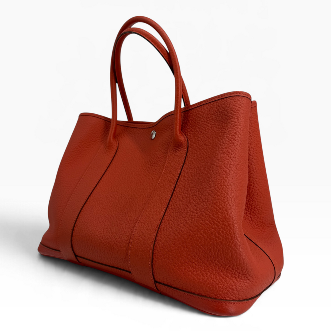Hermès Garden Party 30 Orange Poppy leather tote opposite three-quarter view with inventory tag