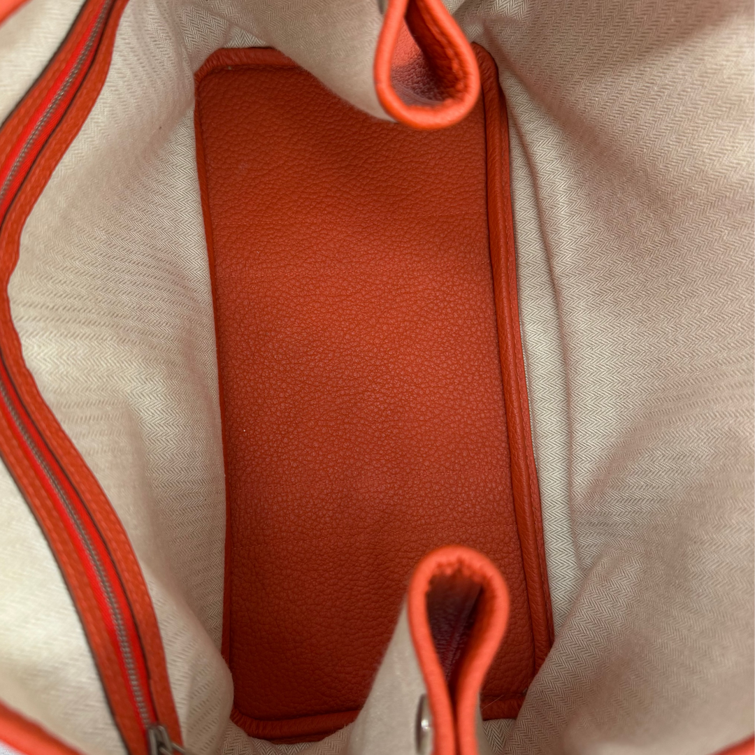 Hermès Garden Party 30 Orange Poppy interior with light chevron textile lining, leather base and zippered pocket