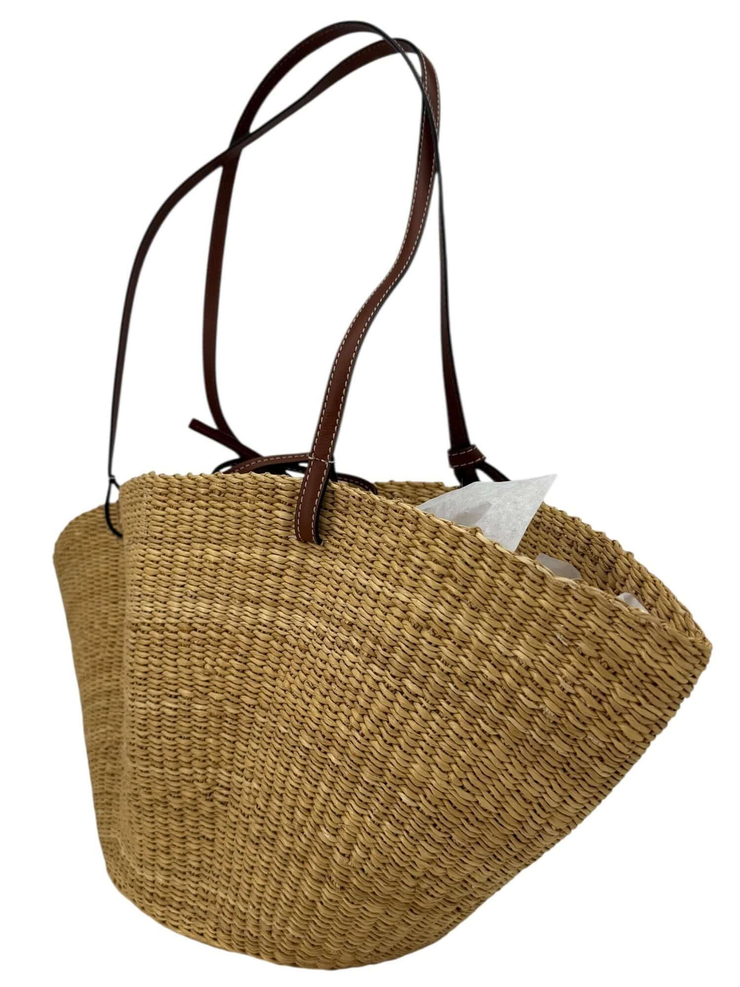 Loewe Raffia Basket Tote in Brown & Natural Tan | LuxLoveLouis showcasing its handcrafted design and refined leather straps.