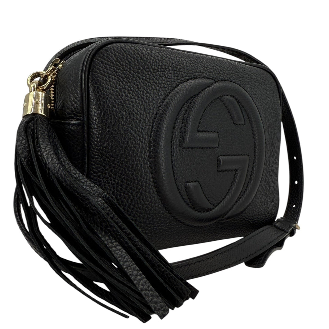 Gucci Soho Disco Small Crossbody bag in black pebbled calfskin with tassel. Stylish and versatile mini bag for everyday use.