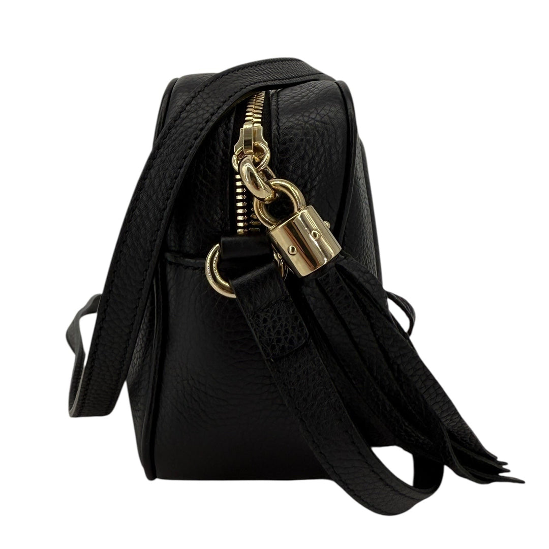Gucci Soho Disco Small Crossbody bag in black pebbled calfskin with tassel, showcasing zipper and gold hardware.