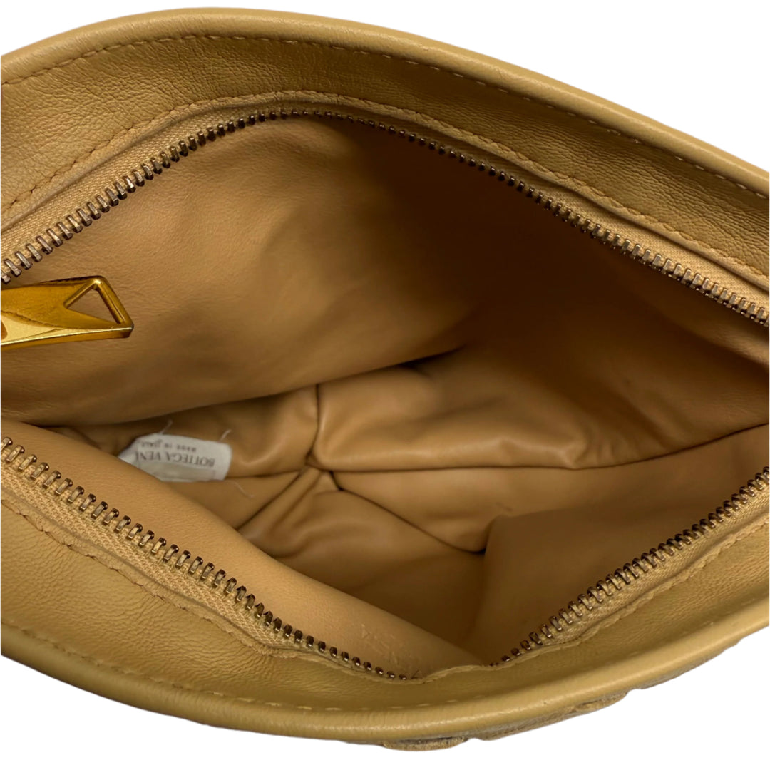 Interior view of Bottega Veneta Nappa Intrecciato BV Twist Clutch, showcasing soft leather lining and zipper details.
