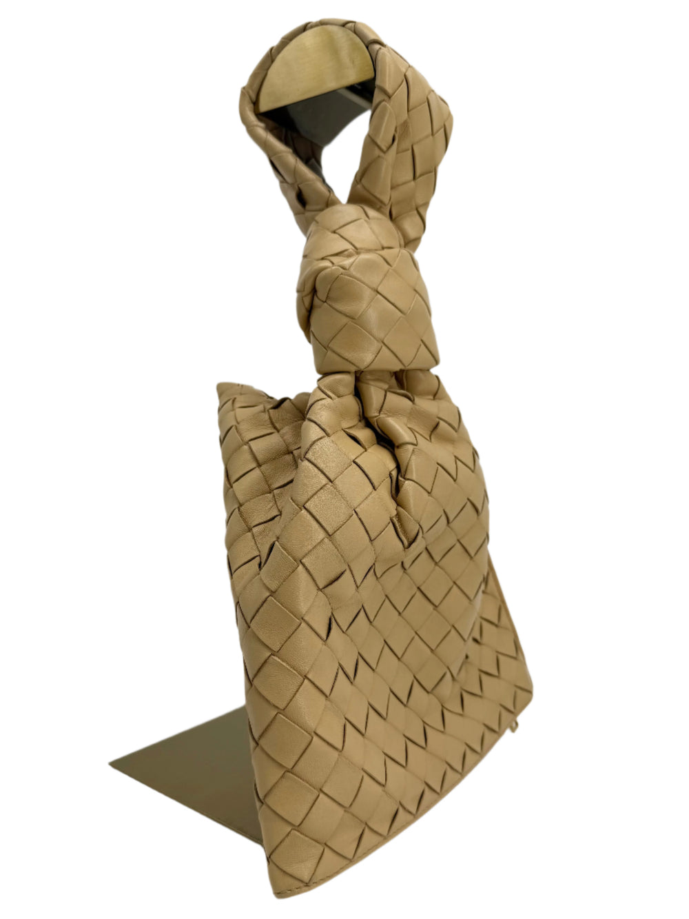 Bottega Veneta Nappa Intrecciato BV Twist Clutch in beige woven lambskin with knotted detail.