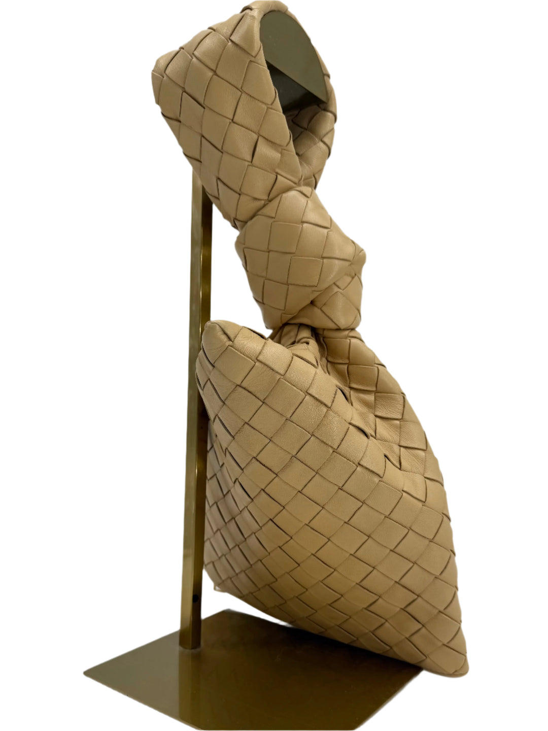 Bottega Veneta woven nappa leather twist clutch on display, showcasing its unique architecture and artisanal craftsmanship.