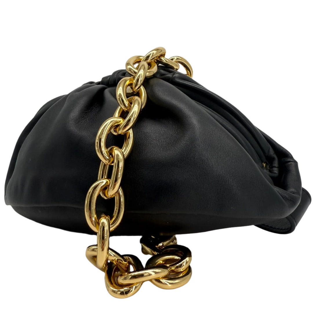Bottega Veneta The Pouch Chain black calfskin leather handbag with gold chain strap, showcasing its elegant ruched design.