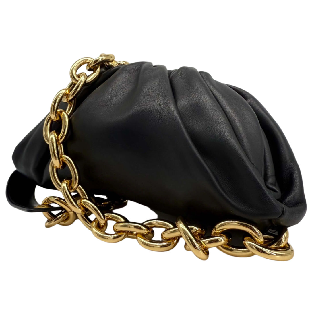 Bottega Veneta The Pouch Chain bag in calfskin leather with gold chain strap, showcasing its sculptural design.
