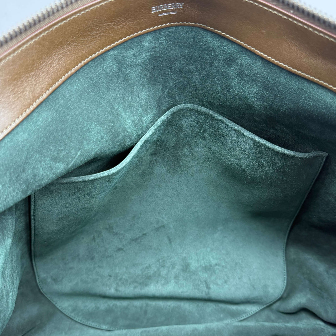 Interior view of Burberry Large Knight Shoulder Bag showcasing soft green lining and leather details.