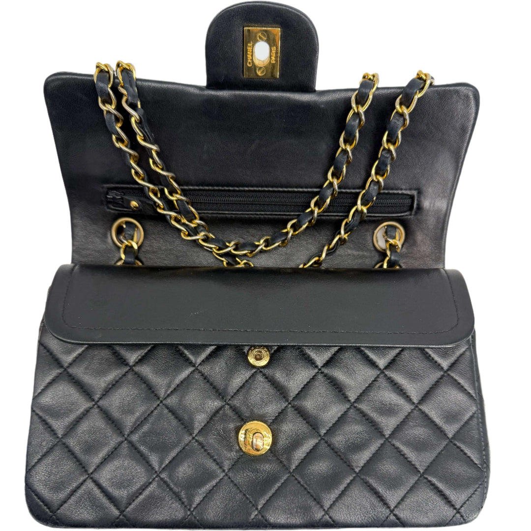 Inside view of CHANEL Black Lambskin Quilted Small Double Flap Bag with gold hardware and chain strap.