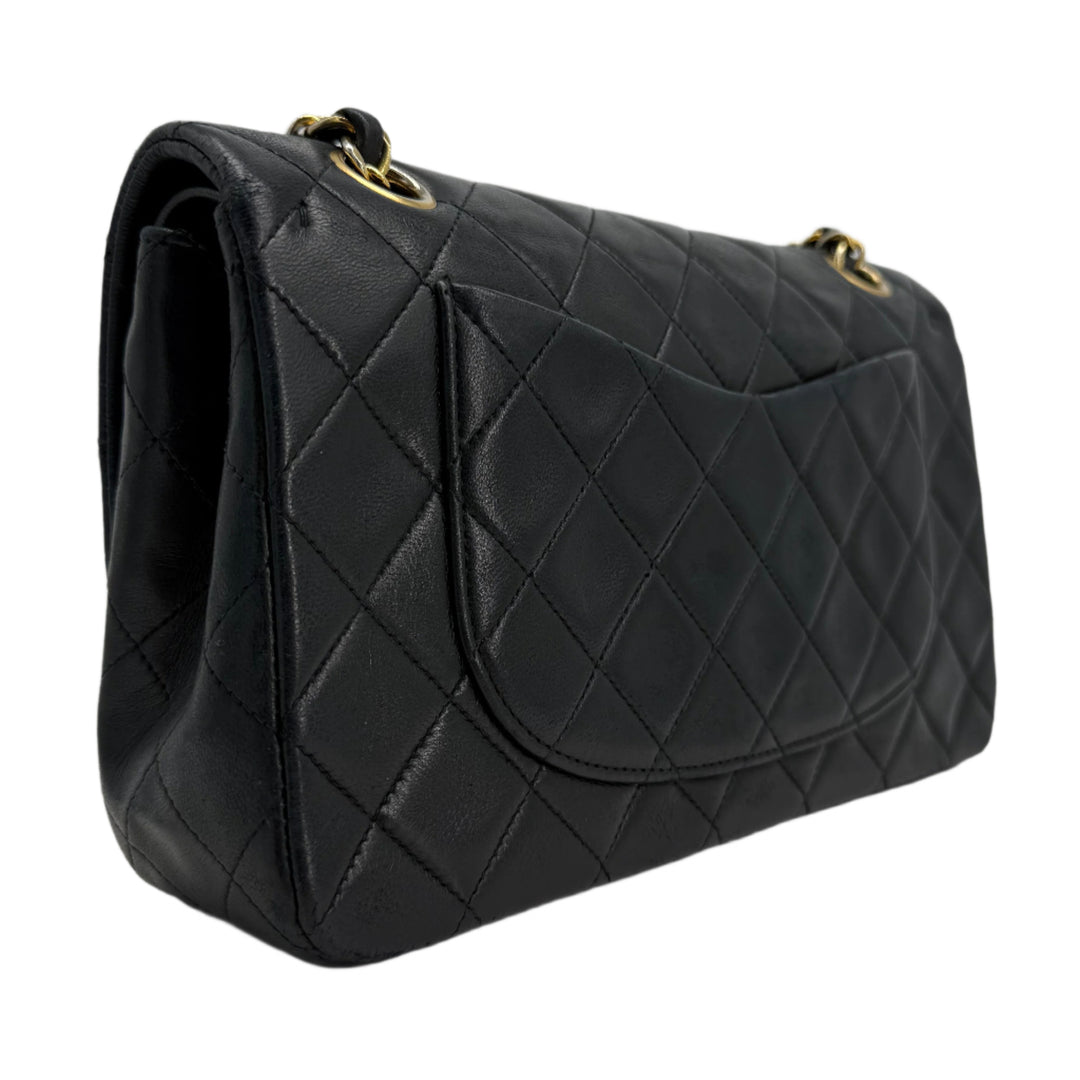 CHANEL Lambskin Quilted Small Double Flap Bag in black with gold hardware showcasing elegant diamond quilt pattern.