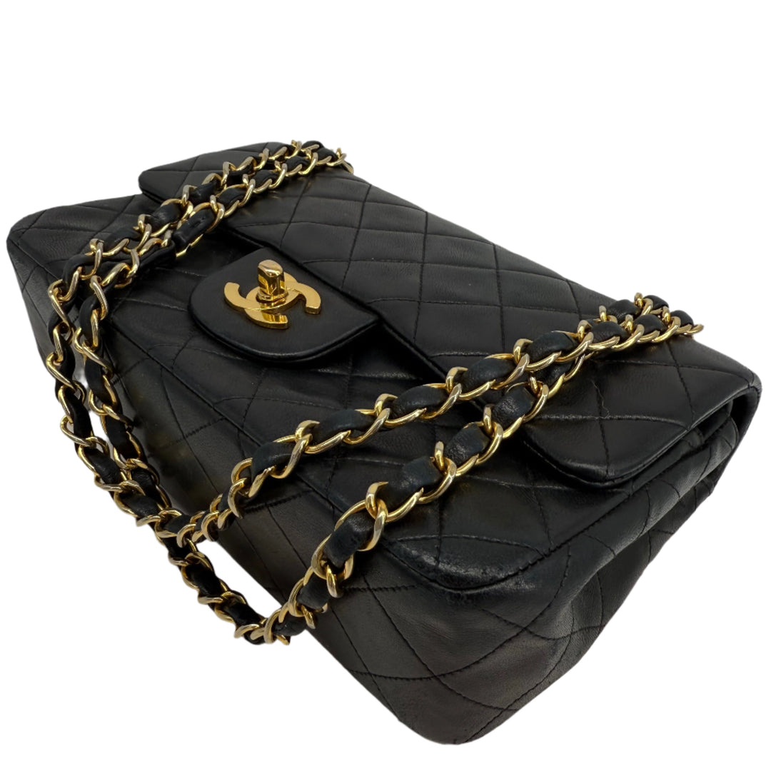 CHANEL Lambskin Quilted Small Double Flap Bag in black with gold hardware, showcasing luxury and elegance.