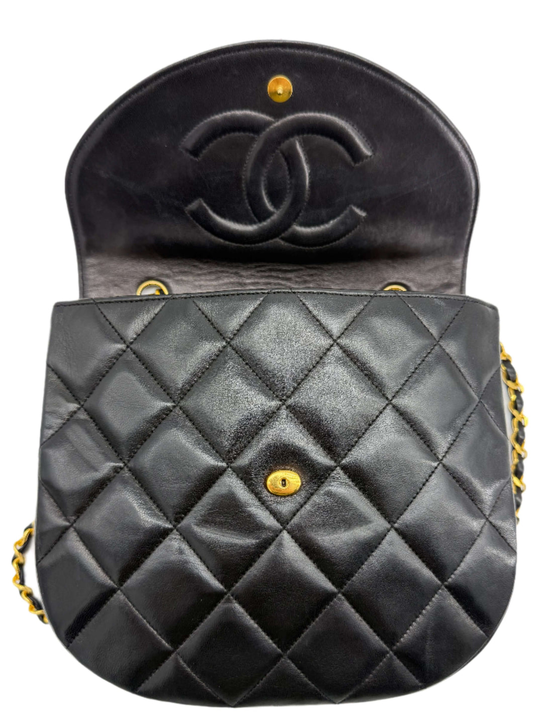 Interior view of Chanel Lambskin Quilted Small Single Flap Bag in black, featuring diamond quilting and gold hardware.