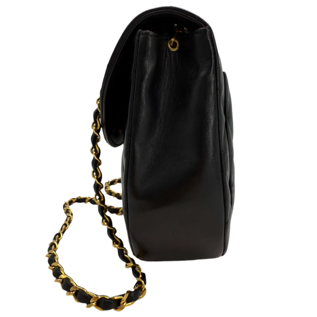 Chanel Lambskin Quilted Small Single Flap Bag in black, showcasing the side view and gold chain strap detail.