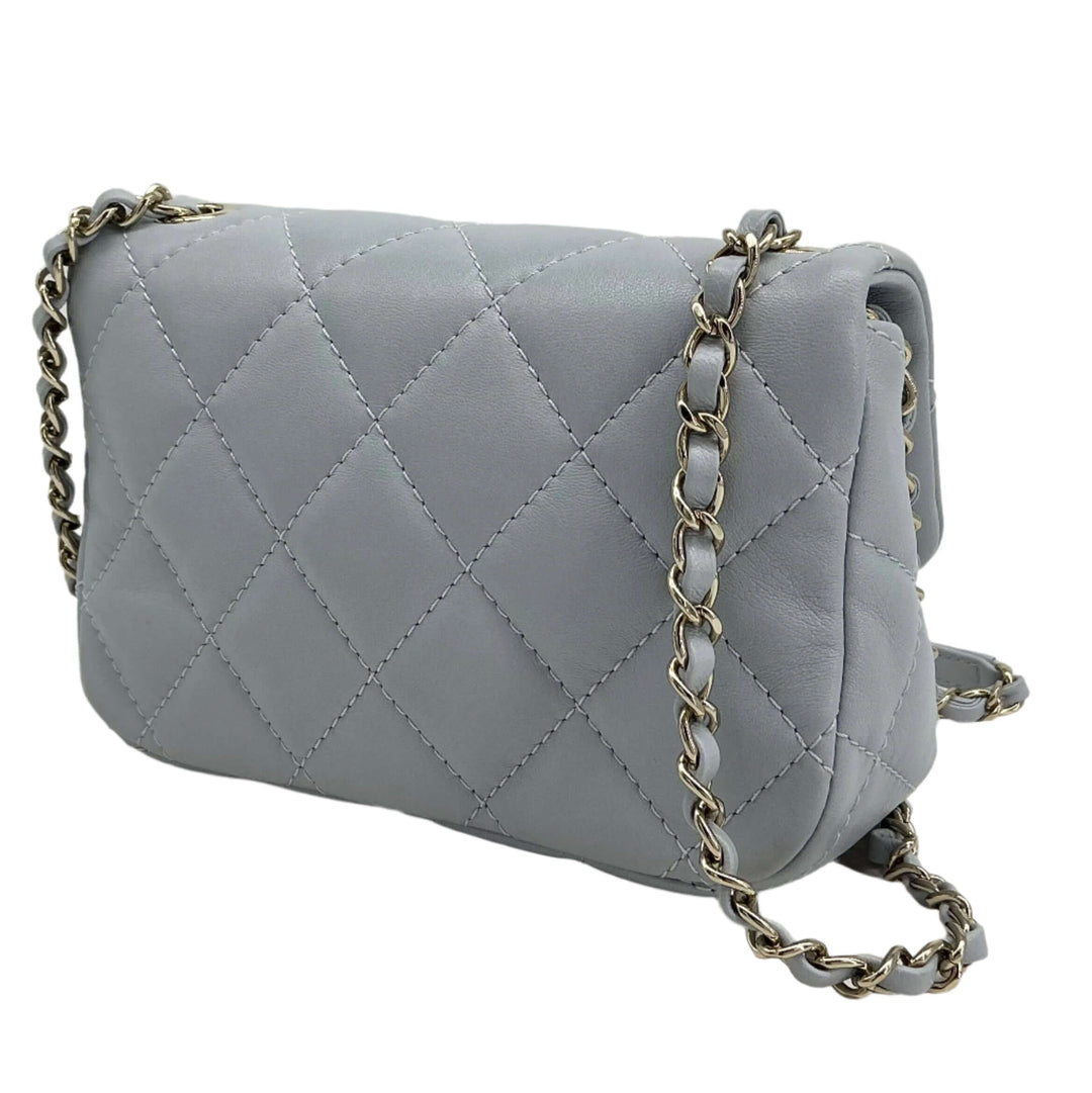 Chanel Mini Chain Around Flap Bag in quilted calfskin leather with crossbody strap, showcasing elegant design and craftsmanship.