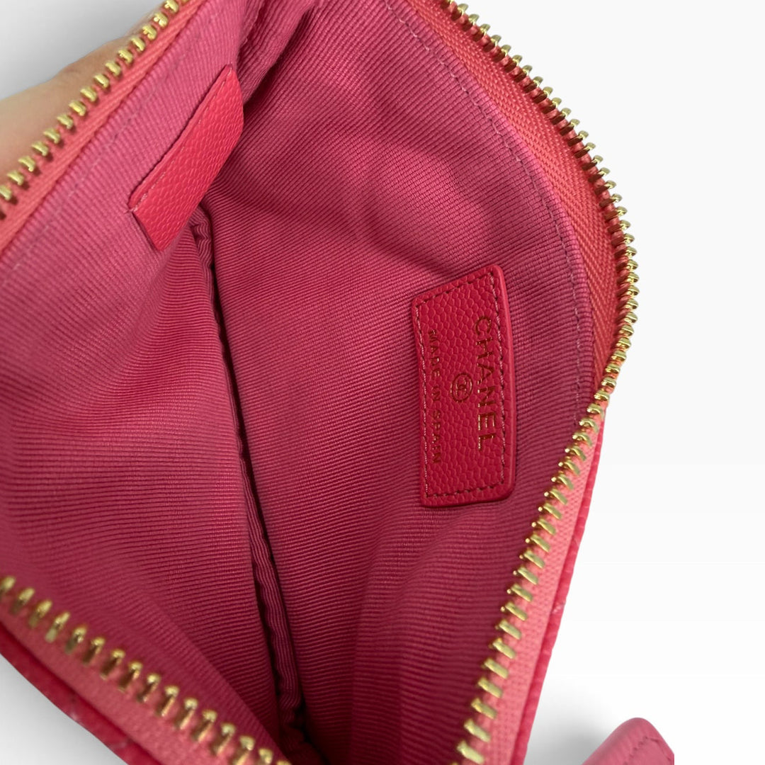 Pink textile-lined interior of CHANEL Mini O-Case red quilted zip pouch with stitched CHANEL label