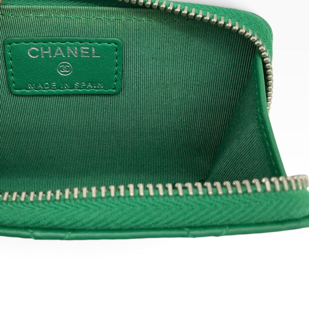 Chanel green quilted zipped key holder interior with green lining, zipper hardware, and Chanel Made in Spain marking