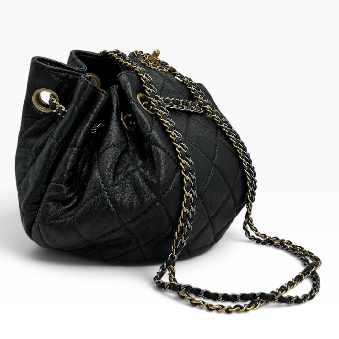 Chanel Small 19 Bucket Bag black angled view showing quilted calfskin and gold-tone chain hardware
