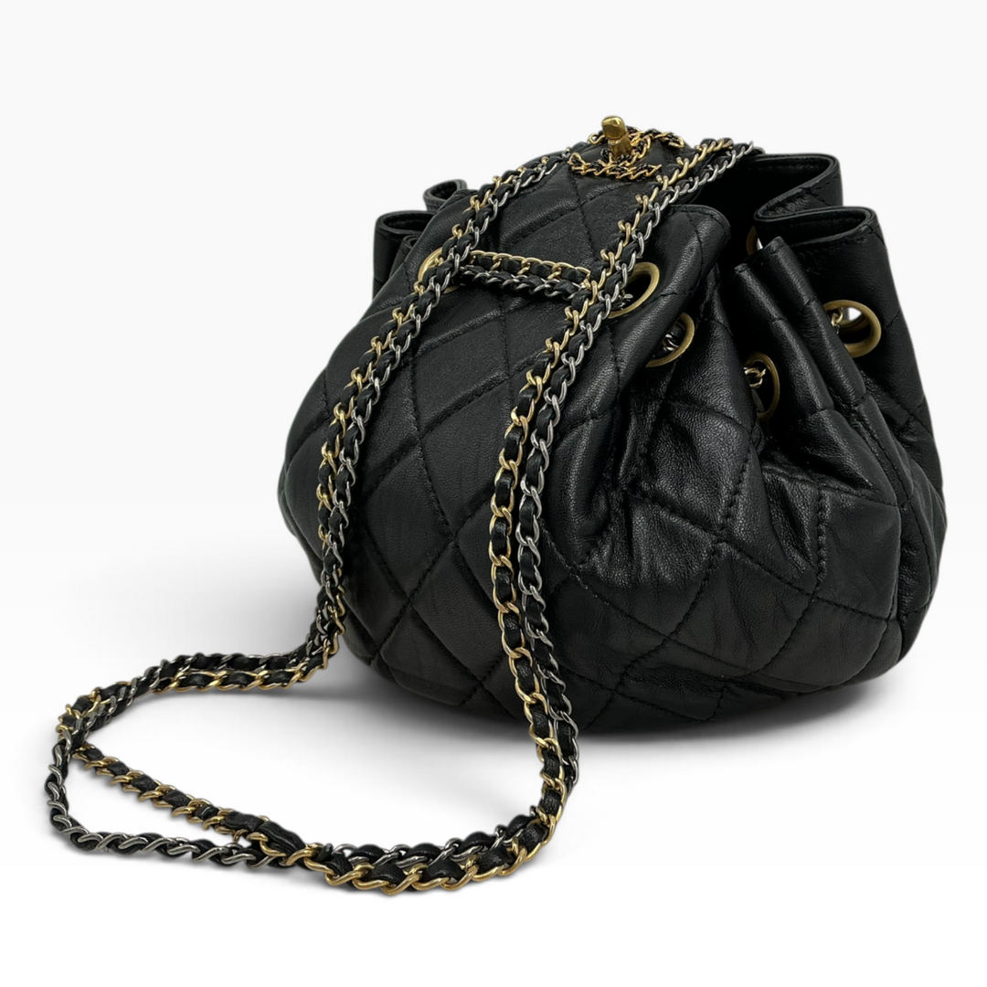 Chanel Small 19 Bucket Bag black angled view showing quilted calfskin and gold-tone chain hardware