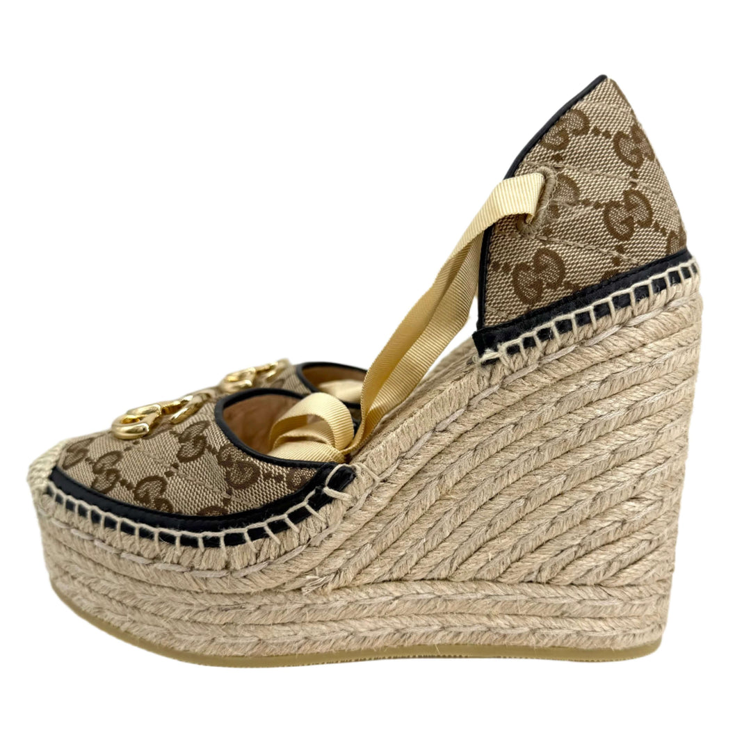 Gucci GG Marmont Monogram Matelassé espadrille wedges in beige and ebony canvas with woven jute wedge.