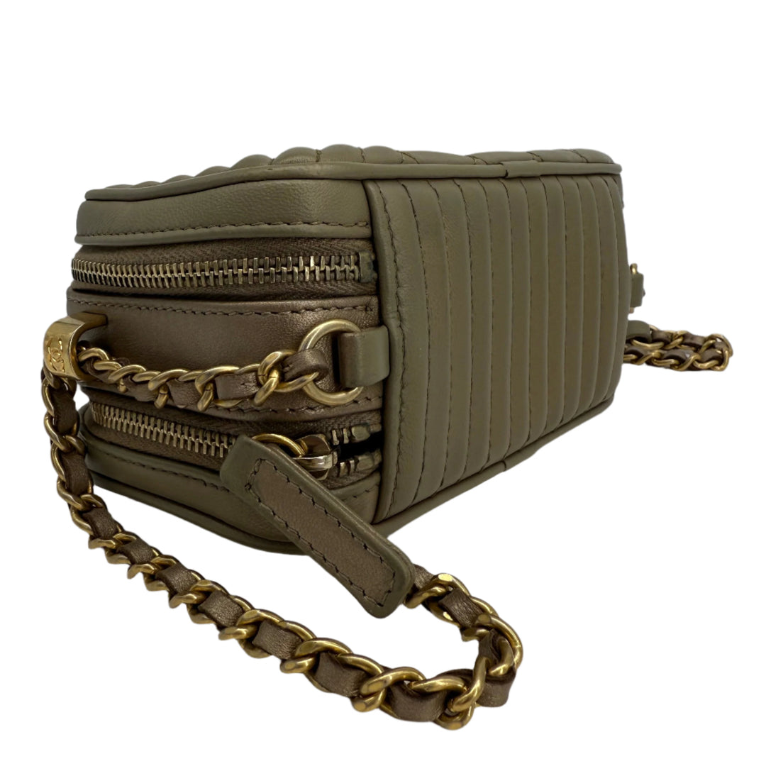 Gucci GG Marmont Small Shoulder Bag in olive green leather with gold chain strap, featuring quilted texture and zippers.