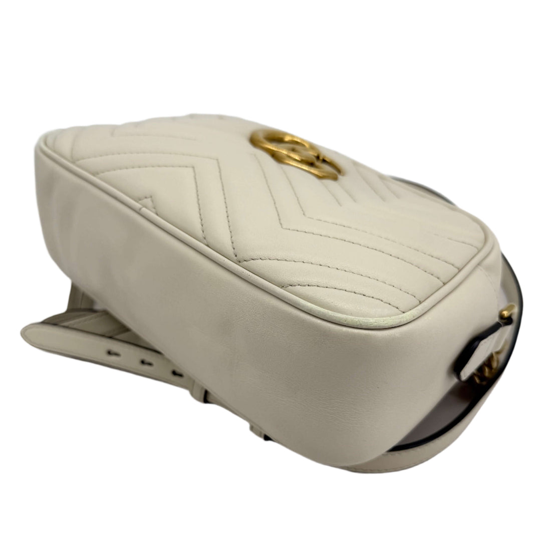 Gucci GG Marmont Small Shoulder Bag in white matelassé calfskin with antique gold GG logo and chain strap.