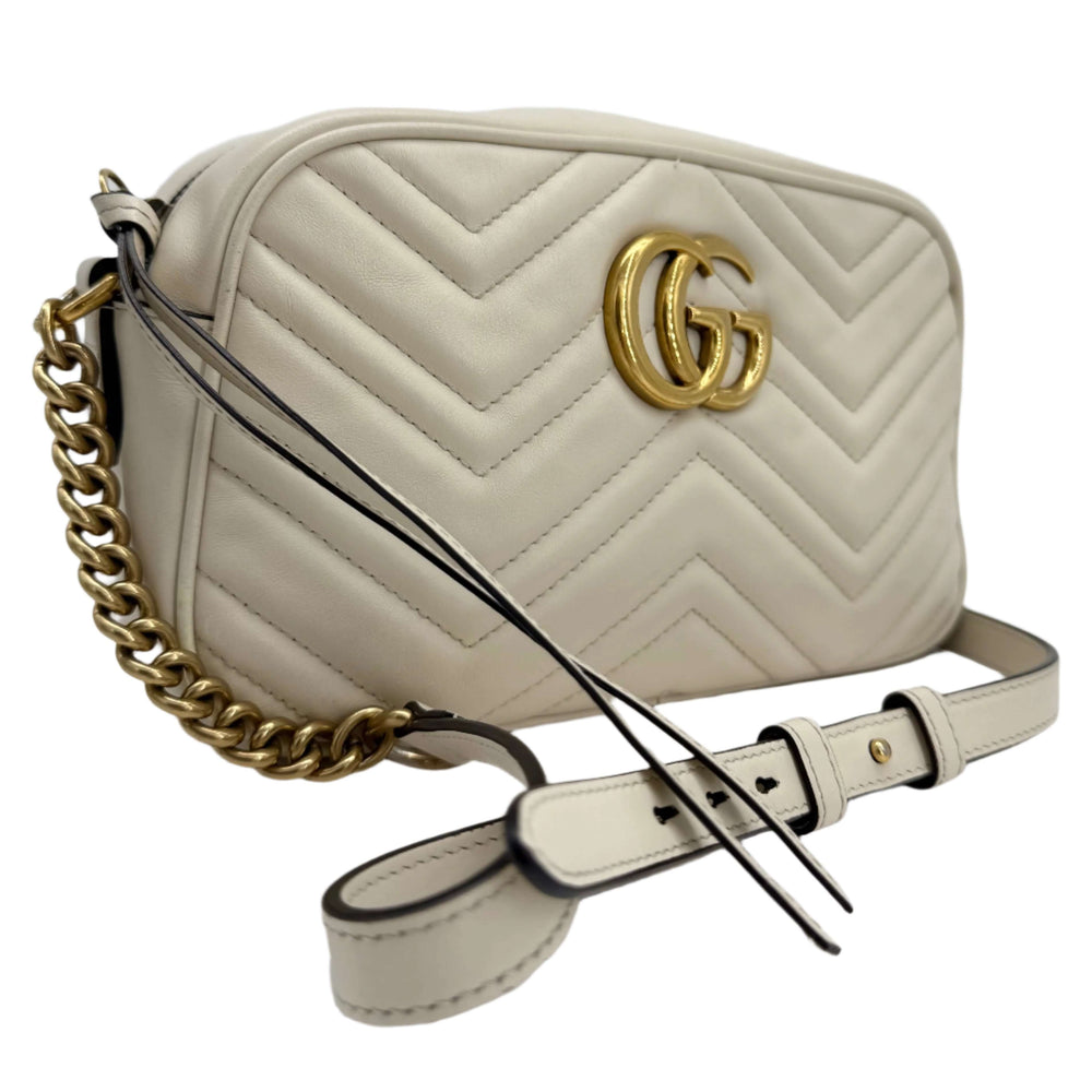 Gucci GG Marmont Small Shoulder Bag in white matelassé calfskin with antique gold chain and interlocking GG logo.