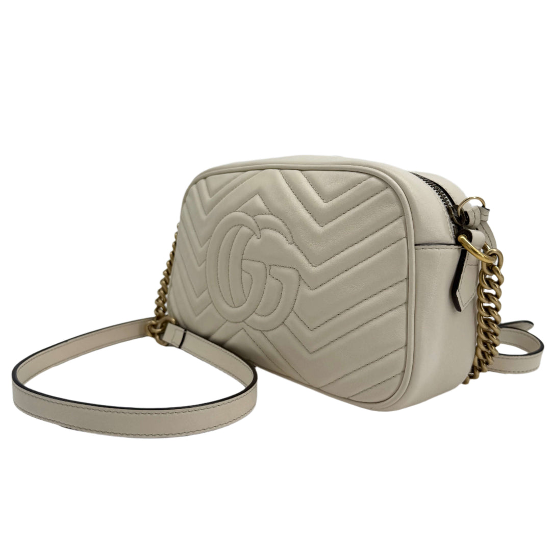 Gucci GG Marmont Small Shoulder Bag in white matelassé calfskin with antiqued gold chain strap.