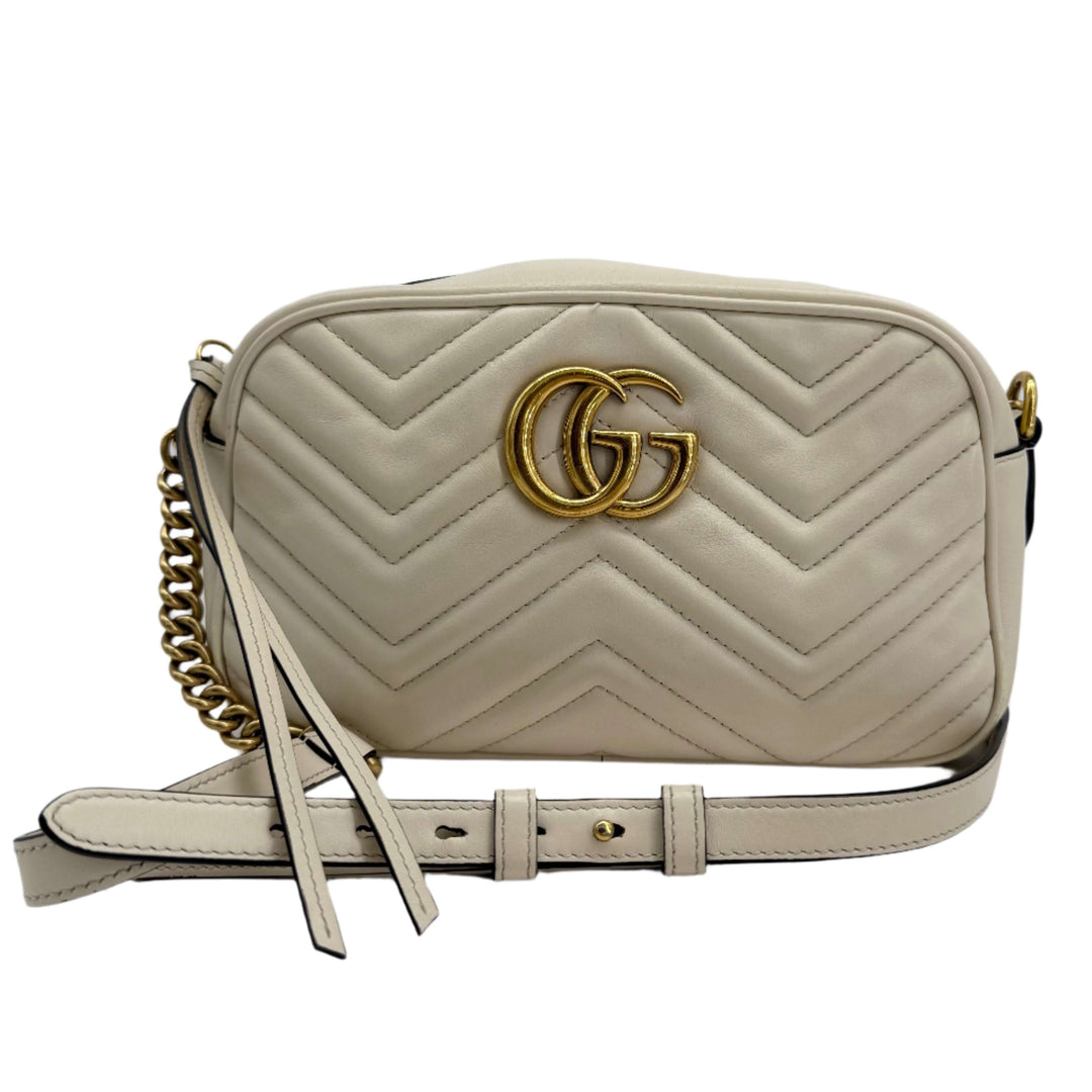 Gucci GG Marmont Small Shoulder Bag in white matelassé calfskin with antiqued gold chain detail.
