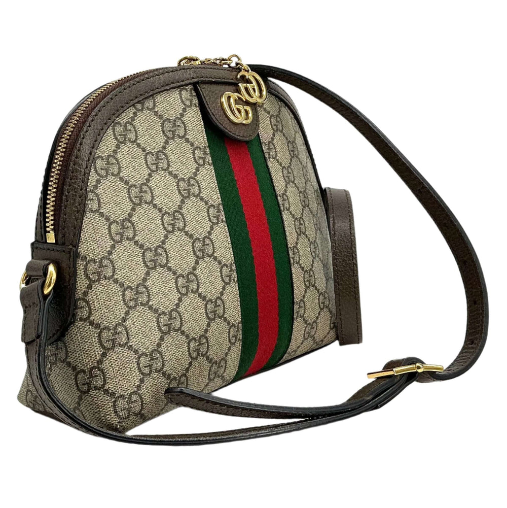Gucci GG Supreme Dome Shoulder Bag featuring iconic Web stripe and Double G charms, crafted from durable canvas.