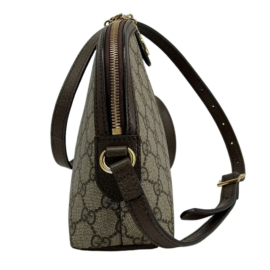 Side view of Gucci GG Supreme Dome Shoulder Bag showcasing the iconic GG canvas and brown leather trim.