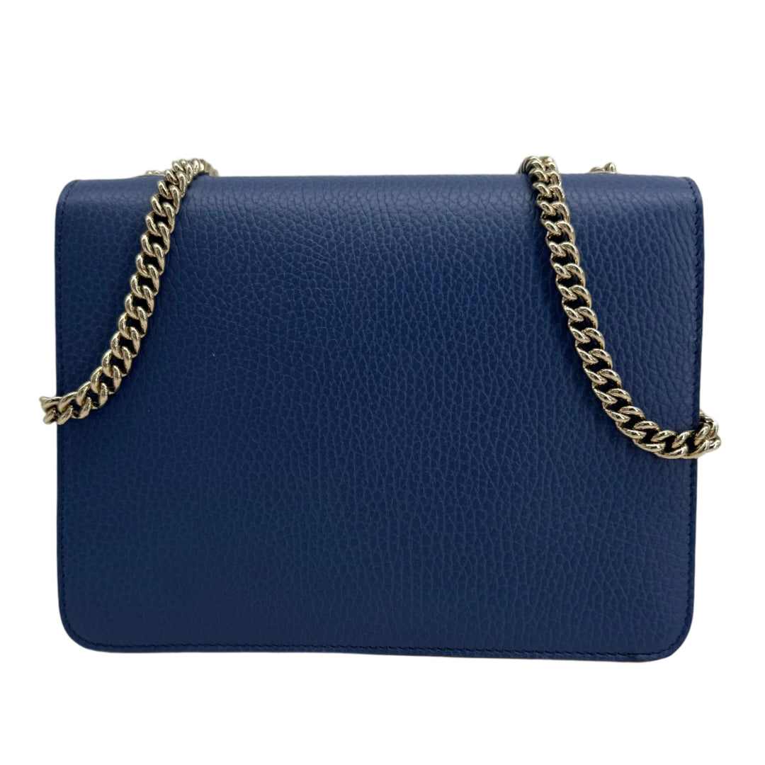 Gucci Interlocking G Small Shoulder Bag in dollar calfskin leather with light gold-tone chain strap.