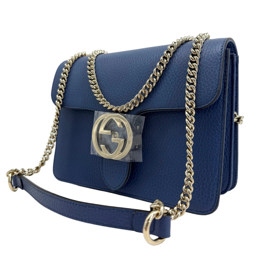 Gucci Interlocking G Small Shoulder Bag in blue dollar calfskin leather with gold-tone chain strap and GG turn-lock closure.