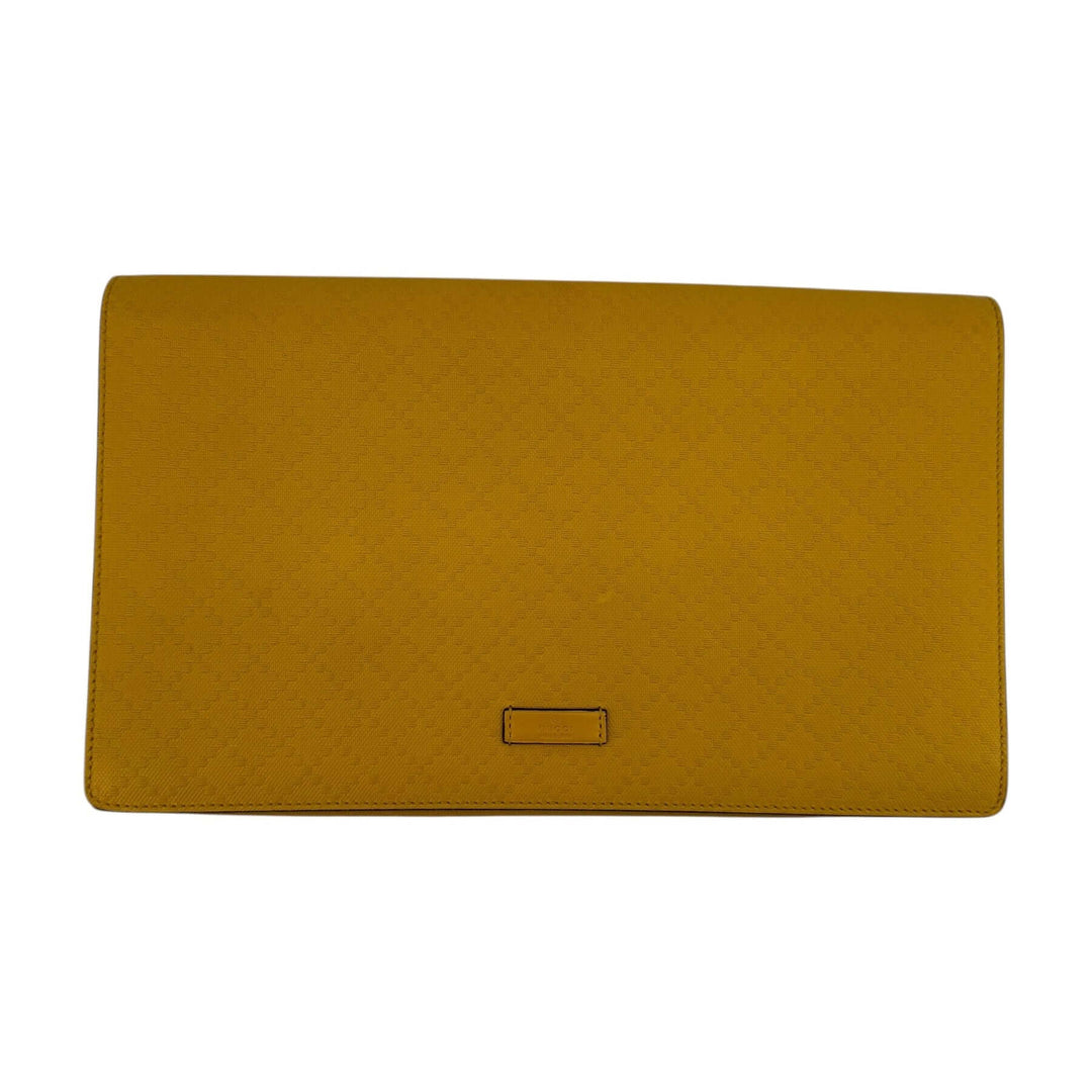 Gucci Ochre Yellow Diamante Leather Oversized Flap Clutch featuring textured leather and gold-tone hardware.
