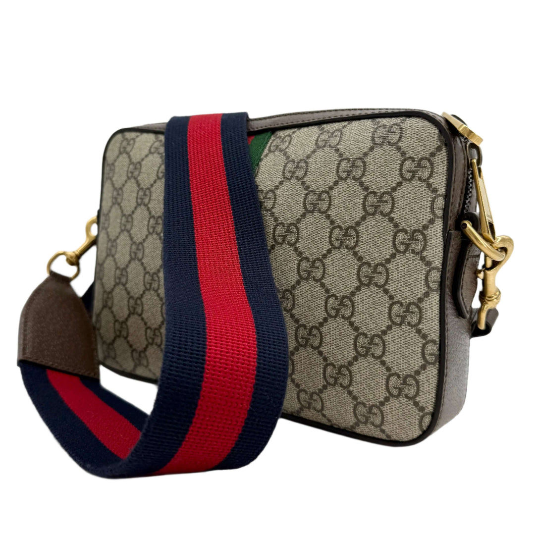 Gucci Ophidia Crossbody Bag in GG Supreme Canvas with classic Web Strap, showcasing timeless luxury and functionality.