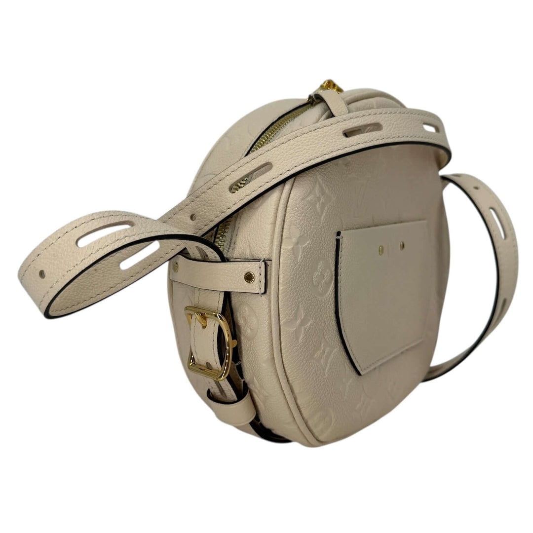 Louis Vuitton Empreinte Boîte Chapeau Souple MM – Creme side view with strap and detailed texture.