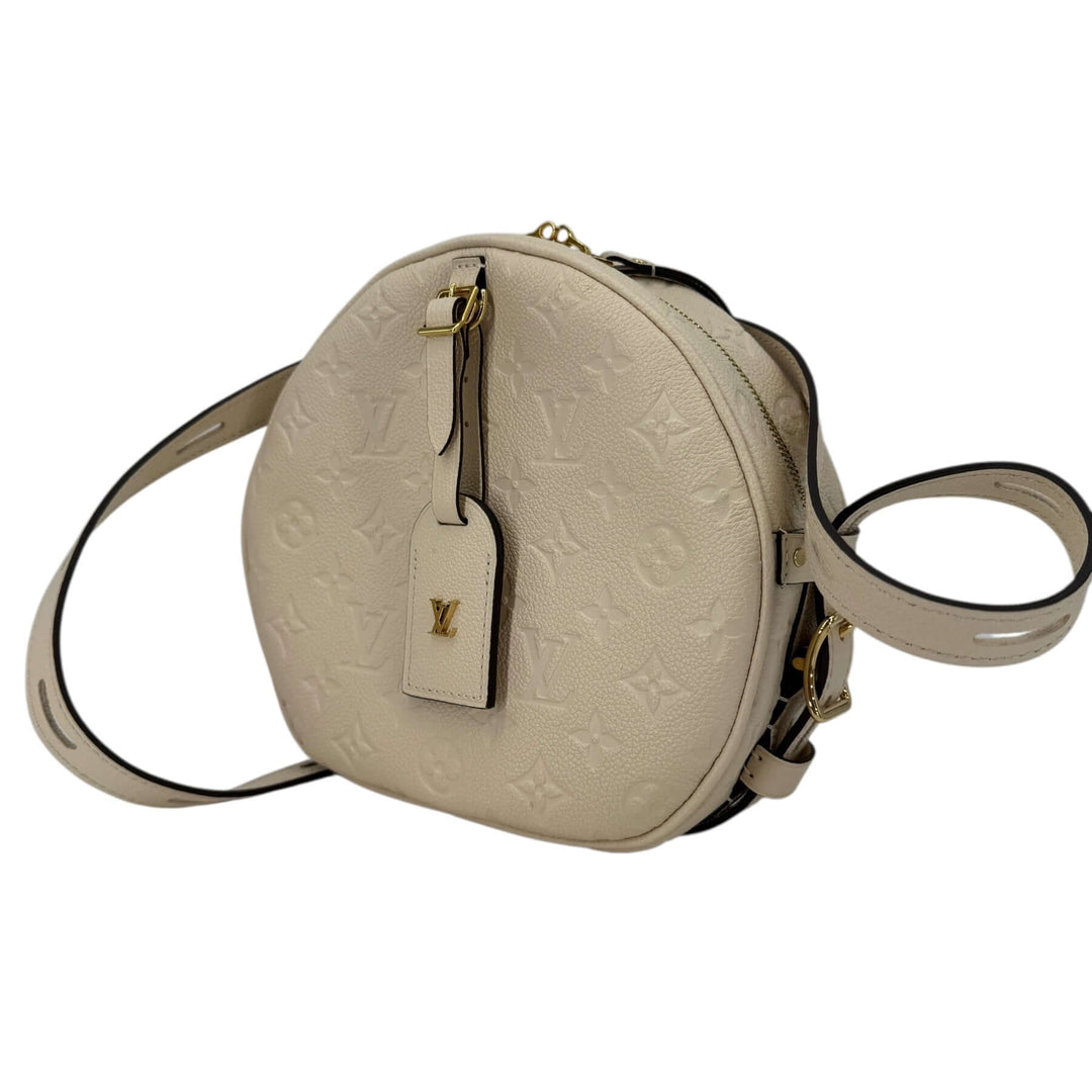 Louis Vuitton Empreinte Boîte Chapeau Souple MM – Creme with an elegant round shape and shoulder strap.