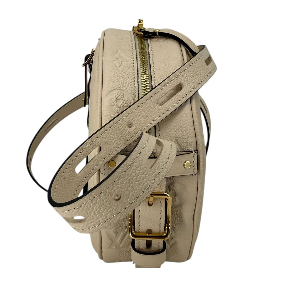 Louis Vuitton Empreinte Boîte Chapeau Souple MM – Creme side view showcasing the texture and strap design.
