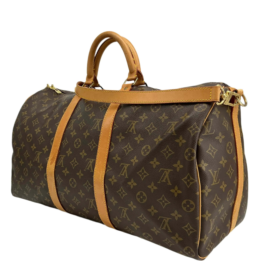 Louis Vuitton Keepall Bandouliere 50 travel duffel bag in monogram canvas with vachetta leather accents.