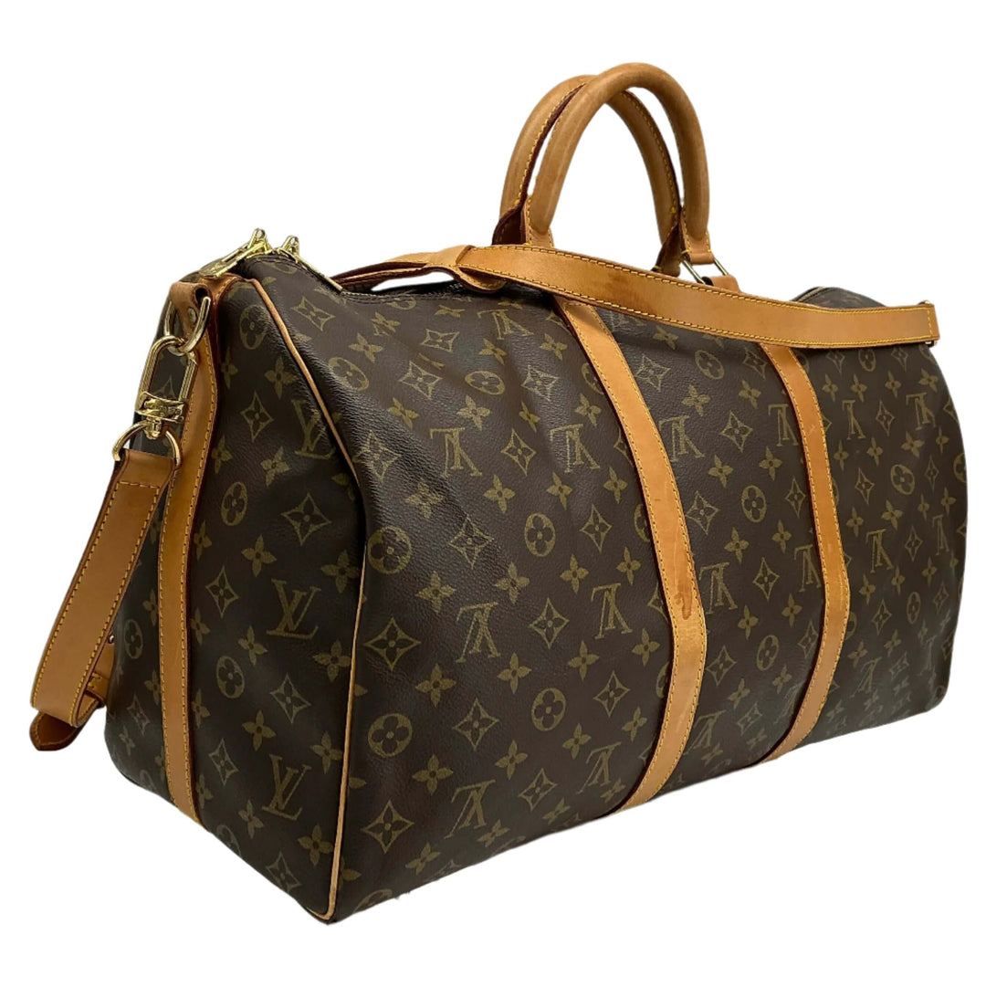 Louis Vuitton Keepall Bandouliere 50 travel duffel bag in monogram coated canvas with vachetta leather accents.
